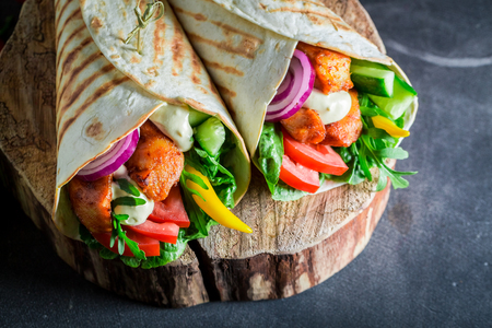 Healthy grilled tortilla with fresh vegetables and chickenの写真素材