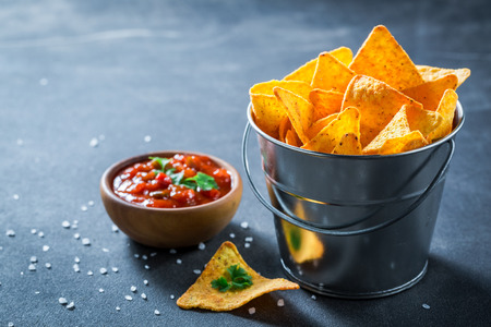 Mexican nachos with salt and spicy red sauceの写真素材