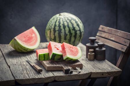 Juicy watermelon on an old wooden tableの写真素材