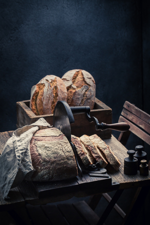 Fresh loaf of bread with flour and crumbsの写真素材