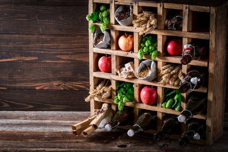 Various fresh beer ingredients in old wooden boxの写真素材