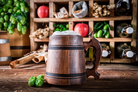 Various beer ingredients and beer with foamの写真素材