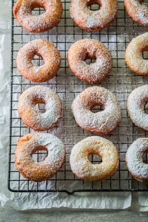 Yummy and homemade golden donuts with powdered sugarの写真素材