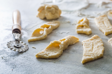 Cutting from fresh dough sweet and tasty donutsの写真素材