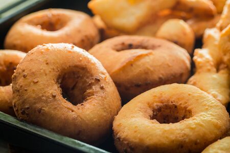 Homemade and delicious golden donuts with powdered sugarの写真素材