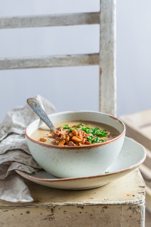 Enjoy your mushrooms soup on old wooden tableの写真素材