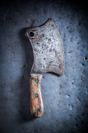 Rustic metal chopper on old metal tableの写真素材
