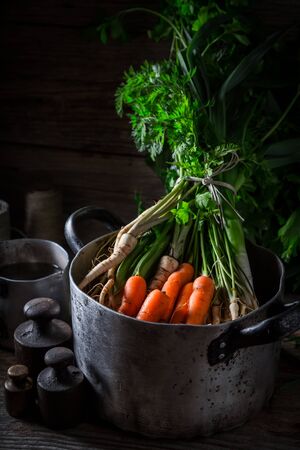 Preparation for homemade vegan soup with carrots, parsley and leekの写真素材