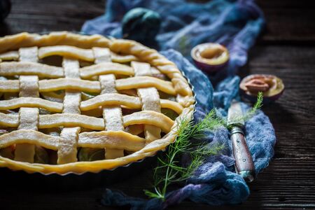Homemade and delicious plum pie on blue clothの写真素材