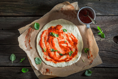 Delicious pizza made of cheese, tomatoes and herbsの写真素材