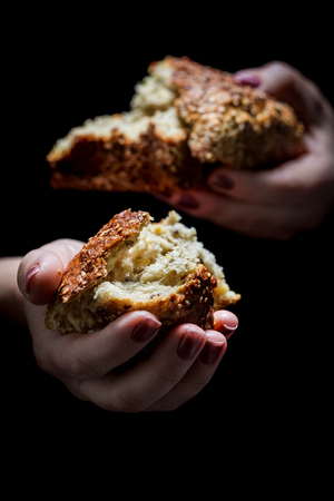 Homemade loaf of bread in the woman hands