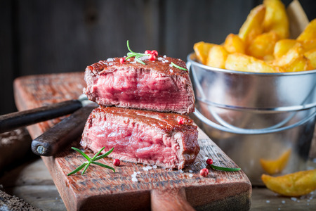 Closeup of homemade steak and chips with salt and rosemaryの写真素材
