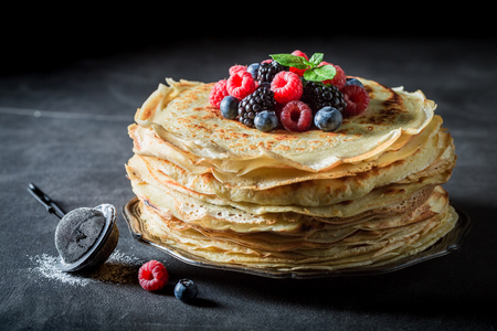 Big stack of pancakes with blueberries and raspberriesの写真素材