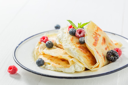 Tasty pancakes with curd, berries and powder sugarの写真素材