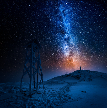 Man looking to the stars in the mountain in winter の写真素材