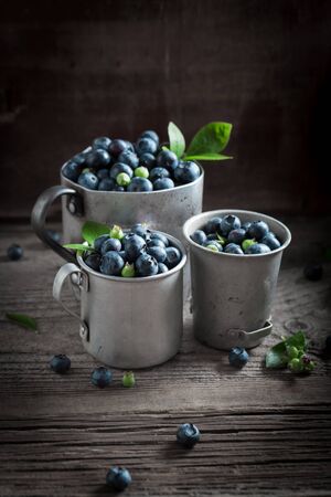 Full of vitamins blueberry on old wooden rustic floorの写真素材
