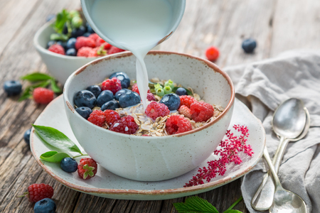 Healthy granola with fresh blueberries and raspberriesの写真素材