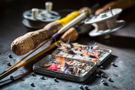 Handmade fishing tackle with fishing flies and rodsの写真素材
