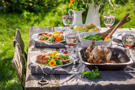 Fresh dinner with salad and chicken served in summerの写真素材