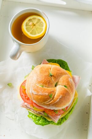 Healthy sandwich with ham, cheese, tomatoes and teaの写真素材