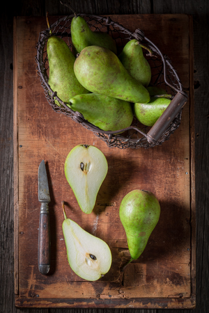 Green Pears in an old wire basketの写真素材