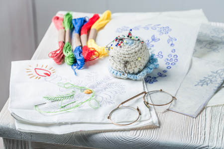 Embroidered napkins with color mulina on white tableの写真素材