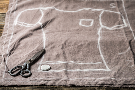 Tailor pattern of shirt and scissors on clothes