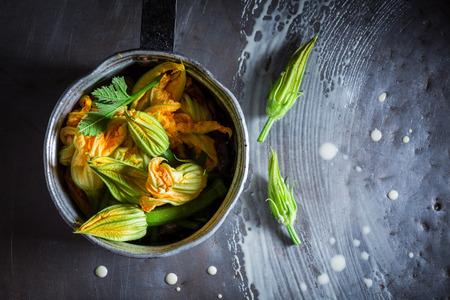 Preparation for homemade fried zucchini flower made of pancake batterの写真素材