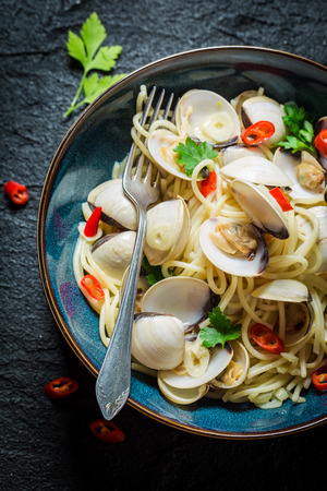 Closeup of spaghetti Vongole on black rockの写真素材