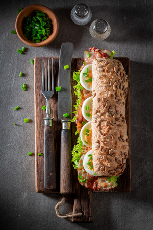 Delicious sandwich with eggs, bacon and lettuceの写真素材