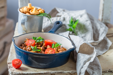 Tasty fried mushrooms with cherry tomatoes and parsleyの写真素材