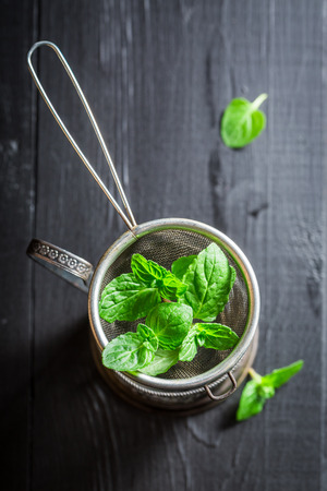 Brewing fresh and aromatic green tea on old wooden tableの写真素材