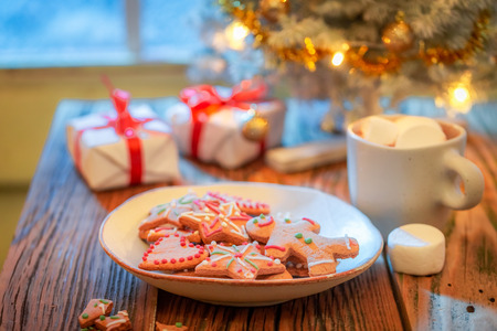Gorgeous Christmas tree and gifts with frozen window and lightの写真素材