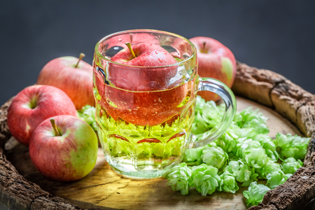 Fresh cider beer with wheat, hops and applesの写真素材