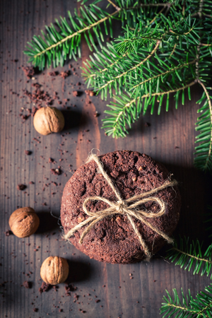 Tasty chocolate cookies with nuts and spruceの写真素材