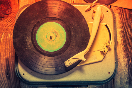 Old record player with a stack of vinyl recordsの写真素材