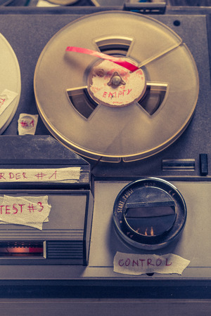 Old reel audio recorder with a few rolls of tapeの写真素材