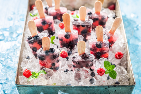 Juicy berry fruits ice cream on a stickの写真素材
