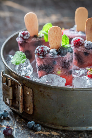 Tasty ice cream with berries on cold iceの写真素材