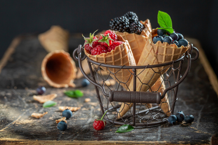 Juicy berry fruits in waffels as ice cream conceptの写真素材