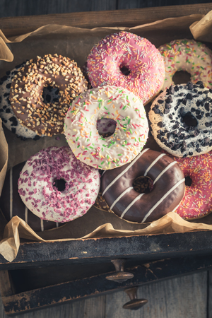 Sweet and tasty donuts in old wooden boxesの写真素材