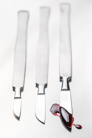 Closeup of scalpels with a small amount of bloodの写真素材