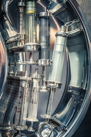 Vintage needle and syringes in a stainless steel containerの写真素材