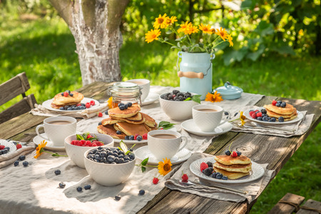 Delicious pancakes with raspberries, blueberries and honeyの写真素材