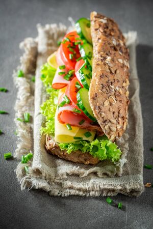 Tasty sandwich with ham, lettue and chive for breakfastの写真素材