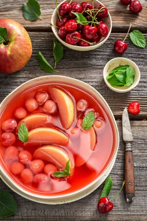 Delicious fruit soup with fresh apples and cherriesの写真素材