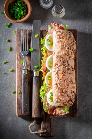 Homemade sandwich with eggs and lettuce, baconの写真素材