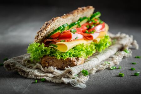Delicious sandwich with ham, lettue and chive for breakfastの写真素材
