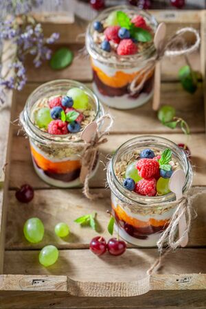 Homemade granola with fresh berries and yoghurt in jarの写真素材