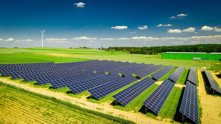 Amazing aerial view of solar panels on green fieldの写真素材